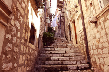 narrow street with stairs and bricks