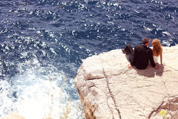 groom and bride relaxing near water