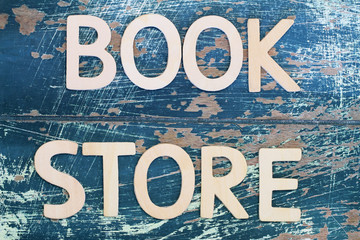 Bookstore written with wooden letters on rustic wooden surface © graletta