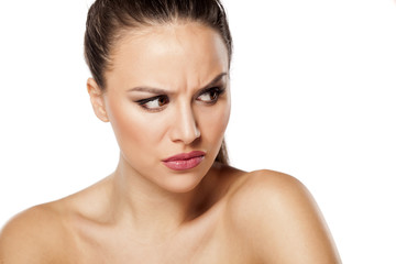 Obraz premium angry beautiful woman looking aside on a white background