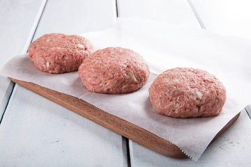 Fresh homemade raw  ground  beef burgers.