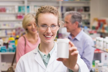 Fototapeta na wymiar Pharmacist holding medicine jar