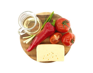 Vegetables on cutting board, isolated on white. Top view