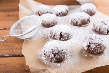 Homemade chocolate crinkles cookies with powdered sugar.