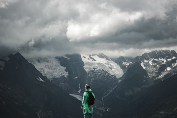 male traveller and summer mountain stormy landscape