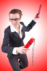 Businesswoman with dynamite on white