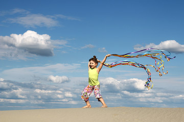 happy little girl playing on beach