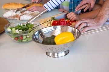 Happy family preparing vegetables together