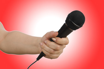 Hand with microphone on white