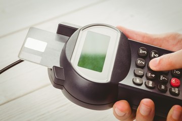 Man entering his pin on terminal