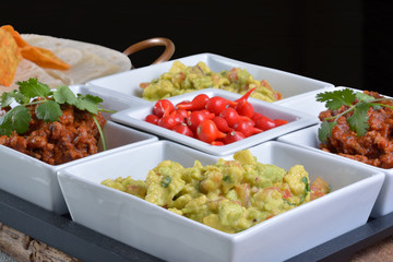 Mexican food - chilli, guacamole, tortillas and nachos