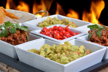 Mexican food - chilli, guacamole, tortillas and nachos