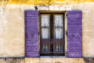 Fototapeta na wymiar Old Window with Shuttes in the South of France