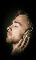 Contented young man listening to his music