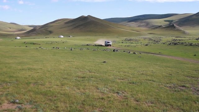 Van crossing in Mongolian landscape