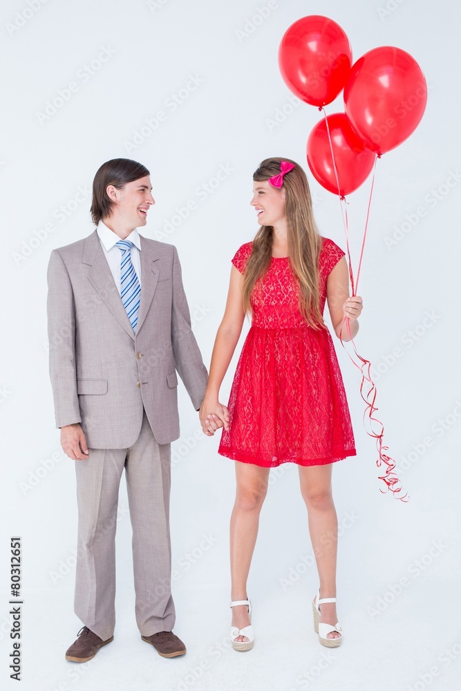 Poster smiling geeky couple standing hand in hand