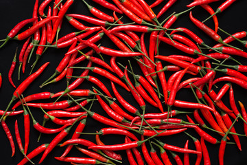 Red chilies on black background