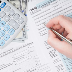 Taxpayer filling out USA 1040 Tax Form
