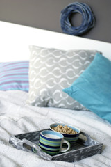 Tray with breakfast on a bed