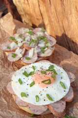 Pork sausage and fried egg with chopped chives sandwich.