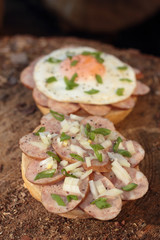 Pork sausage and fried egg with chopped chives sandwich.