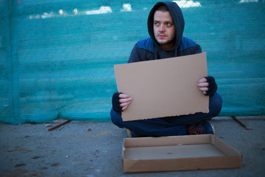 Homeless Man Holds Blank Cardboard For Your Text Stock Photo Adobe Stock Homeless Man Holds Blank Cardboard For Your Text Stock Photo Adobe Stock