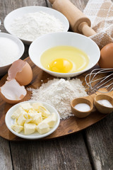 fresh ingredients for baking on a wooden board, vertical