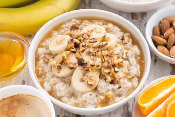healthy breakfast - oatmeal with banana, honey and walnuts