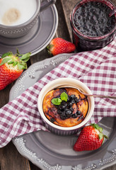 Portion of cottage cheese casserole and cup of coffee