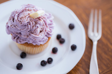 Appetizing muffin with blueberry cream