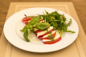 Caprese Salad - salad with tomato, mozzarella cheese and pesto s