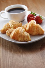 Breakfast with coffee and croissant