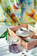 Jar of coffee beans set with a cup of coffee and accessories