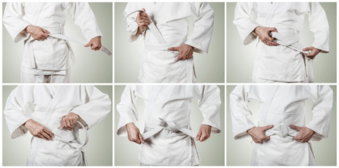 Judoka tying the white belt (obi)