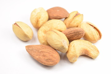 Pile of mixed nuts isolated on a white background.