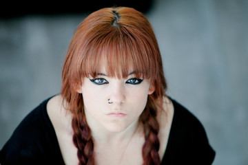 Rebellious teenager girl with red hair