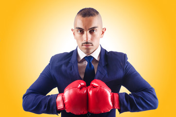 Handsome businessman with boxing gloves