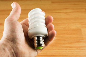 Luminescent light bulb in his hand