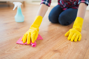 close up of woman with rag cleaning floor at home
