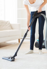 close up of woman with vacuum cleaner at home