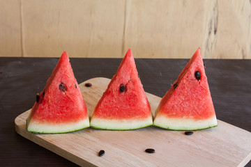 red watermelon on the wooden brackground