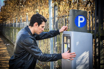 Young man waiting for a parking ticket