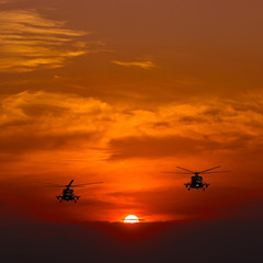 Fototapeta na wymiar Mi-8 helicopters, warm sunset