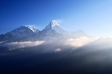 Dramatic sun light over snow capped Annapurna mountain