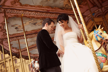 groom and bride in a carousel