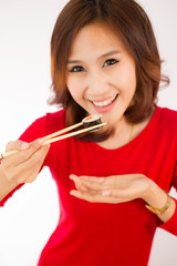 Close-up. young lady eating sushi roll