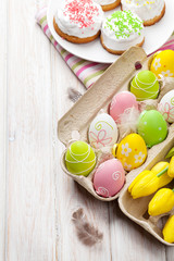 Easter with yellow tulips, colorful eggs and traditional cakes