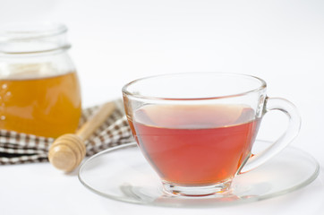 a cup of tea with honey on white background. healty food