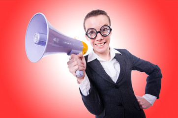 Young businessman with loudspeaker on white