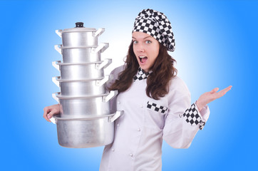 Cook with stack of pots on white